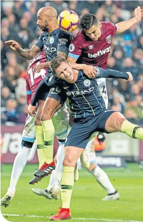  ??  ?? Fabian Balbuena wins an aerial duel with City’s Aymeric Laporte