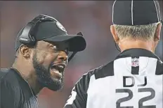  ??  ?? Steelers coach Mike Tomlin argues ball placement with official Steve Stelljes.