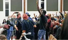  ?? Tom Reel / Staff file photo ?? Supporters of Zekee Rayford, 18, disrupt a Schertz City Council meeting Nov. 10 with a protest. A video of his arrest spurred concerns of excessive police force.