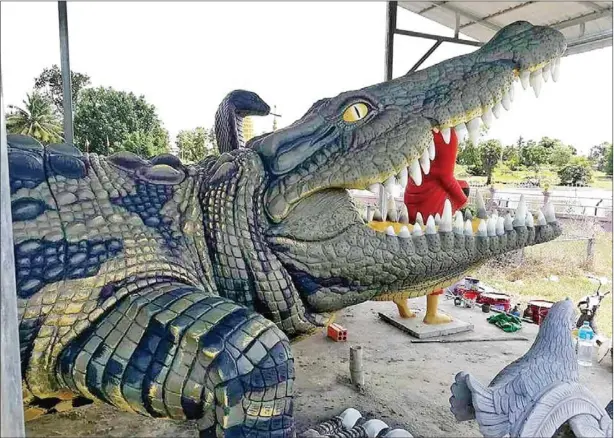  ?? SUPPLIED ?? Soth Synath spent seven months creating this 13m crocodile sculpture. Many of his sculptures are commission­ed by pagoda committees to decorate temple areas.