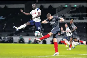  ?? PHOTO: REUTERS ?? Hang time . . . Brentford’s Vitaly Janelt clears the ball despite the attention of Tottenham Hotspur’s Davinson Sanchez during their League Cup semifinal yesterday.