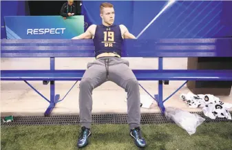  ?? Joe Robbins / Getty Images ?? Christian McCaffrey, ripped for skipping the Sun Bowl, takes a break at the NFL combine.