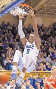  ?? BEN MCKEOWN/ASSOCIATED PRESS ?? Duke freshman RJ Barrett dunks during the second half Wednesday as the No. 3 Blue Devils pulled away from visiting Hartford. Barrett had 27 points and a seasonbest 15 rebounds in an 84-54 victory.