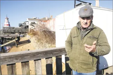  ?? Ned Gerard / Hearst Connecticu­t Media ?? Joe Henriques, owner of H&amp;H Shellfish, stands on one of his docks as he describes how he and his workers found the body of a woman on the small beach, below, early Sunday morning in Bridgeport. On Monday, the victim was identified as 25-year-old Emily Todd, of Bethel, and confirmed that she died from a bullet wound to the head.