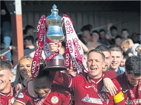  ?? ?? CHAMPS: Kelty Hearts captain Michael Tidser lifts the League 2 trophy after their match with Forfar Athletic in April.
