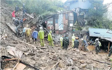  ?? REUTERS Picture: ?? DESPERATE SEARCH: Rescuers look for residents buried in a landslide at the height of typhoon Mangkhut that hit Baguio City, Philippine­s