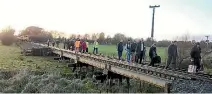  ?? PHOTO: MICHAEL WOODCOCK ?? Commuters walking along the rail track after a service broke down last year.