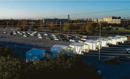  ?? Elizabeth Conley / Staff photograph­er ?? Vehicles head to NRG Park last month for a vaccine drive-thru. The area will be used by FEMA for vaccines starting on Feb. 24.