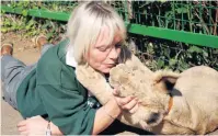  ??  ?? PLAYMATE Daughter Lynn shares a cuddle with lion cub