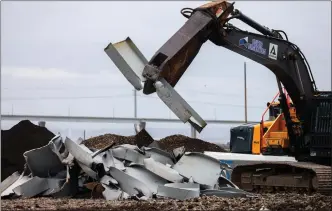  ?? JULIA NIKHINSON - THE ASSOCIATED PRESS ?? A shearer breaks apart salvaged pieces of the collapsed Francis Scott Key Bridge at Tradepoint Atlantic on Friday in Sparrows Point, Md.