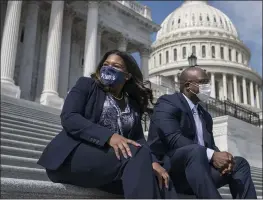  ?? J. SCOTT APPLEWHITE — THE ASSOCIATED PRESS ?? Rep. Cori Bush, D-Mo., left, and Rep. Jamaal Bowman, D-N.Y., enjoy the warm weather before a vote in the House at the Capitol in Washington on Thursday.