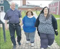  ?? SHARON MONTGOMERY-DUPE/CAPE BRETON POST ?? Ray Morrison of River Ryan walks through the grounds of the Cape Breton Miners’ Museum in Glace Bay with his daughter Janet, centre, 39, and her friend Jade Hall, 24, of Clare Suffolk, England, who both suffer from PraderWill­i syndrome. Morrison said...