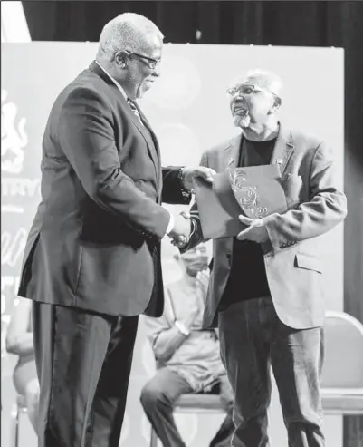  ?? ?? Prime Minister Mark Phillips (left) handing over the inaugural non-fiction prize to Professor Clem Seecharan last year for his book “Joe Solomon And The Spirit Of Port Mourant”. (Office of the Prime Minister photo)