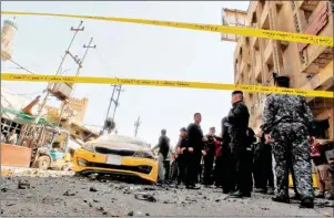  ?? SABAH ARAR/AFP ?? Iraqis gather at the site of the car bomb explosion near Baghdad’s Al-Shuhada Bridge yesterday.