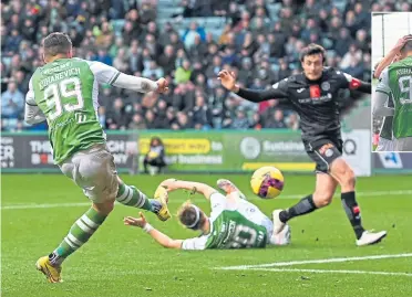  ?? ?? Striker Mykola Kukharevyc­h fires the ball home to extend Hibs’ lead to 2-0