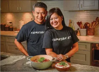  ?? ATLANTA JOURNAL-CONSTITUTI­ON FOOD STYLINGS BY AMOR MIA ORIÑO AND CARLO GAN / PHOTOS BY CHRIS HUNT FOR THE ?? Carlo Gan (left) and Amor Mia Oriño, who have the Filipino pop-up and catering business Kamayan ATL, are shown in their Decatur home with the dish sinilihan, which is more widely known as Bicol Express. It’s pork stew in coconut milk with chiles.