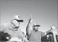  ??  ?? IN VENTURA COUNTY, Lanny Mosley, left, has been showing fellow inmate Gerardo Moran the ropes. Both are “swampers,” the unofficial right hand of the fire captain who manages them.