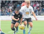  ??  ?? Ayr’s Jamie Adams’ challenge on Adil Nabi was ruled no penalty