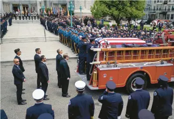  ?? JOHN MINCHILLO/AP ?? Funeral service: Hundreds of mourners pay their respects Thursday in Newark, New Jersey, to firefighte­r Augusto “Augie” Acabou, 45, who died July 5 while fighting a fire aboard the Grande Costa d’avorio, an Italian-flagged vessel that was docked at Port Newark. Firefighte­r Wayne “Bear” Brooks Jr., 49, also died in the blaze. His funeral will be held Friday.