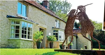  ??  ?? INDULGENT: A deep tub, above, in the eaves room. Left: Boxing hares artwork in the grounds