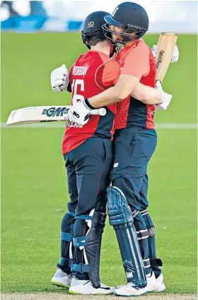  ??  ?? Record: Eoin Morgan (left) and Dawid Malan celebrate during their 182-run stand