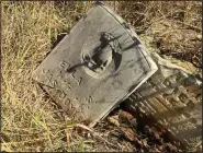  ?? NWA Democrat-Gazette/LAURINDA JOENKS ?? Abby Burnett found this broken gravestone in the abandoned Packsaddle cemetery near Waldron. At one point, this cemetery included at least 24 headstones on marked graves. Earlier this month, Burnett counted only eight. The carving on the stone shows a...