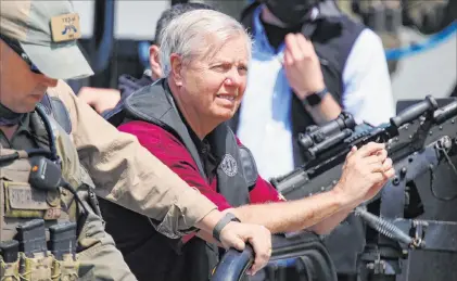  ?? Joel Martinez The Associated Press ?? Sen. Lindsey Graham, R-S.C., looks around Friday as his boat docks after a tour with Texas state troopers and a group of lawmakers at Anzalduas Park in Mission, Texas. Sen. Ted Cruz, R-texas, led a delegation to the border area Friday.