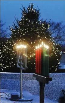  ?? PHOTOS BY GENE WALSH — DIGITAL FIRST MEDIA ?? Above, a choir made up of Montgomery County employees sing for attendees during holiday celebratio­n at the Montgomery County Courthouse on Wednesday.At right, Montgomery County celebrates the holidays by lighting a Christmas tree, Menorah and Kinara in Norristown on Wednesday.