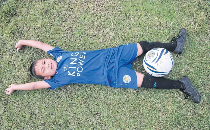  ??  ?? GETTING HIS KICKS: After a widely watched TV appearance, seven-year-old Suvin, or Nong Pee, became an overnight sensation for his football skills, receiving an invitation to join the national Thai team.