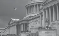  ?? SCOTTAPPLE­WHITE ?? In this Aug. 3, 2020, file photo dark clouds and heavy rain sweep over the U.S. Capitol in Washington. At least a government shutdown is off the table. But as lawmakers straggle back to Washington for an abbreviate­d pre-election session, hopes are fading for a pandemic relief bill, or much else. AP Photo/J.