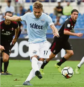  ?? — AP ?? Deadly man: Ciro Immobile scoring a penalty for Lazio in the Serie A match against AC Milan at the Olympic Stadium in Rome on Sunday.