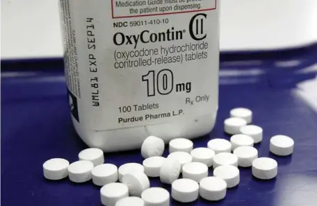  ?? AP FILE ?? KILLER HELD TO ACCOUNT: OxyContin pills are seen in Vermont. The maker of the opioid behind a nationwide addiction crisis, Purdue Pharma, has settled a criminal case against it, agreeing to pay $8.3 billion in fines. Below, the headquarte­rs of Purdue Pharma in Stamford, Conn.