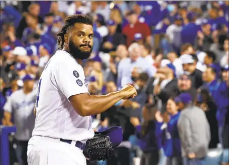  ?? Robert Gauthier Los Angeles Times ?? KENLEY JANSEN walks off after retiring the side in the ninth inning of the wild-card game against St. Louis. He was almost unhittable in the playoffs, giving up three hits in seven scoreless innings and striking out 14.