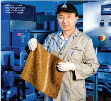  ?? PHOTOGRAPH­Y: COURTESY IMAGES ?? MRE expert Dr Tom Yang holding ‘osmotic meat’, a ‘roll-up’-style field-ration prototype.