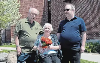  ?? JESSICA NYZNIK/EXAMINER ?? George Flavell, left, his wife Karen and son Mark gather outside The Salvation Army on Thursday. Known as the king pin of the Salvation Army Christmas hampers, George was honoured for 32 years of volunteeri­sm.