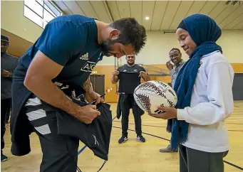  ?? JOSEPH JOHNSON/STUFF ?? All Black Sam Whitelock signs items for 9-year-old Faduma Aweys during a skills and meet and greet session in Christchur­ch yesterday.