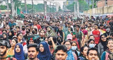  ?? AFP ?? Students shout slogans during a protest march as they demand justice for victims killed in the recent nationwide violence over job quotas, in Dhaka, on Saturday.