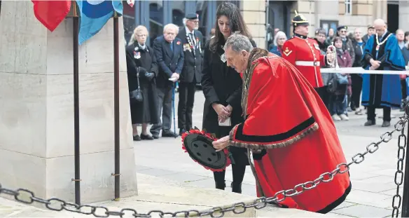  ?? ?? Mayor of Peterborou­gh Alan Dowson and Mayoress Shabina Qayyum Armistice Day parade at the War Memorial. Councillor­s have again debated the mayor’s attire.