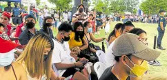  ?? —MARY GRACE OBERES ?? ALL COVERED People continue to wear face masks as they attend the culminatio­n of the National Service Training Program at the St. Francis of Assisi open grounds in the City of Naga in south Cebu on June 10, a day after Cebu Gov. Gwendolyn Garcia lifted the mandatory wearing of masks in open places in the province.