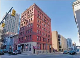  ?? ?? The Sidebar, an iconic basement bar and music venue, is at the northwest corner of East Lexington Street and Guilford Avenue. It’s in the Knickerboc­ker Building, which dates to 1874 and is a survivor of the Great Fire of Baltimore in 1904.