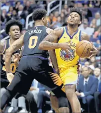  ?? CHRIS CARLSON — THE ASSOCIATED PRESS ?? Warriors guard Nick Young, right, is fouled by Suns forward Marquese Chriss during the first half Saturday night in Phoenix.