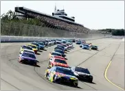  ?? AP PHOTO BY MATT SLOCUM ?? Kyle Busch (18) leads the field on a green flag to start a NASCAR Cup Series auto race at Pocono Raceway, Sunday, in Long Pond, Pa.