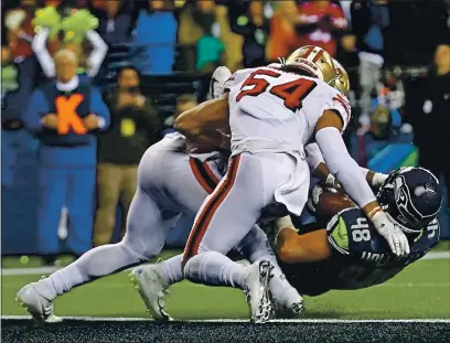 ?? TED S. WARREN — THE ASSOCIATED PRESS FILE ?? Seahawks tight end Jacob Hollister is stopped just short of the goal line by 49ers middle linebacker Fred Warner (54) and linebacker Dre Greenlaw, left, in December of 2019 in Seattle. The 49ers won 26-21.