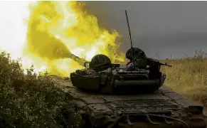  ?? PHOTO: REUTERS ?? Heat of battle . . . Ukrainian servicemen fire toward Russian troops with a tank in the Donetsk region of Ukraine.