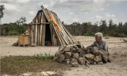  ?? Photograph: Rijasolo/AFP/Getty Images ?? A resident of Fenoaivo village, south-east Madagascar, seen in August this year preparing a small meal amid the intense drought that annually ruins farmers’ cultivatio­n of crops in the region.