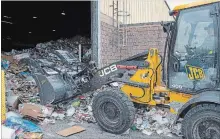  ?? CLIFFORD SKARSTEDT/EXAMINER FILE PHOTO ?? A worker moves recycled waste at the city recycling facility on Pido Rd. People who want to recycle still face challenges, a local resident writes.