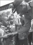  ?? MASTER CORPORAL PAT BLANCHARD, THE CANADIAN PRESS ?? Smith gives donations to students at St. Edwards Primary School in Freetown.