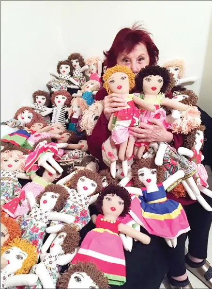  ??  ?? In this photo provided by Lebanese painter Yolande Labaki, Labaki, 93, holds dolls at her house in Beirut, Lebanon, Nov 16, 2020, that she made to be distribute­d to children who might have lost their toys amid the destructio­n or who had otherwise had their lives touched by the Beirut seaport blast in
August 2020. (AP)