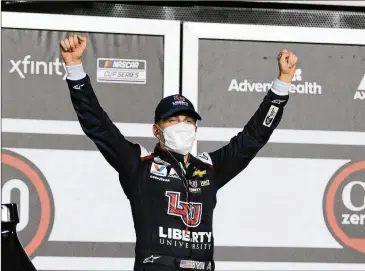  ?? PHOTOS BY TERRY RENNA / AP ?? William Byron celebrates Saturday night in Victory Lane after taking the checkered flag in overtime at the NASCAR Cup Series regular-season finale at Daytona Internatio­nal Speedway in Daytona Beach, Fla.