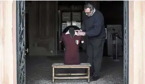  ??  ?? Precious: Volunteer Vito Mazzilli adjusting the jersey of former Grande Torino’s player Ezio Loik at the Museum of Grande Torino and Granata’s Legend in Grugliasco, near Turin. — AFP